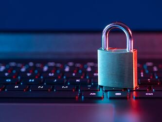 padlock sitting on laptop keyboard